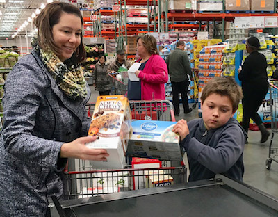 Dr. Misty Curreli purchasing groceries with help from Kai Tvelia